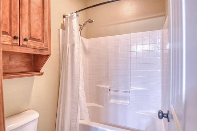 full bathroom featuring toilet and shower / bath combination with curtain