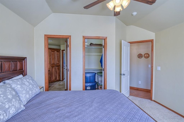 unfurnished bedroom with a closet, carpet flooring, baseboards, ceiling fan, and vaulted ceiling