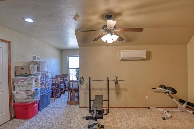 exercise room featuring baseboards, a ceiling fan, carpet flooring, and a wall unit AC