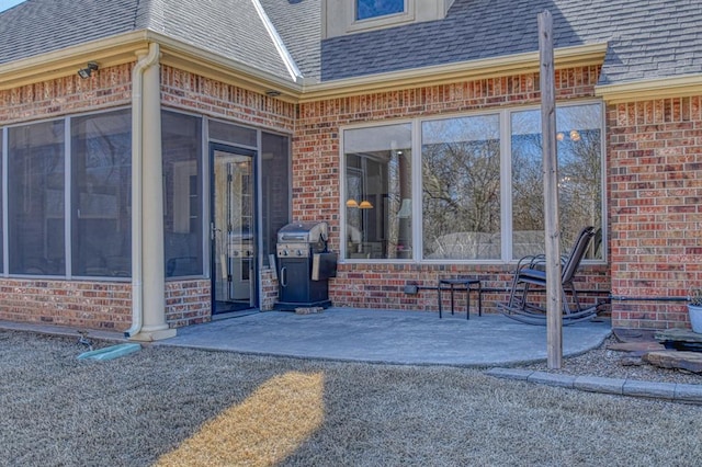 view of patio featuring area for grilling and a sunroom