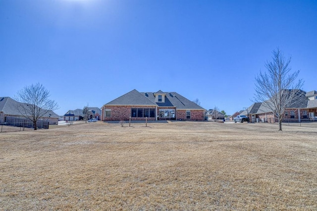 back of property featuring brick siding