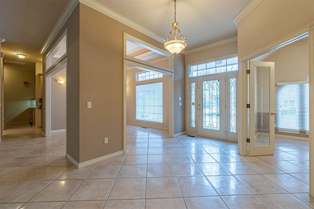 entryway with light tile patterned floors, baseboards, and ornamental molding