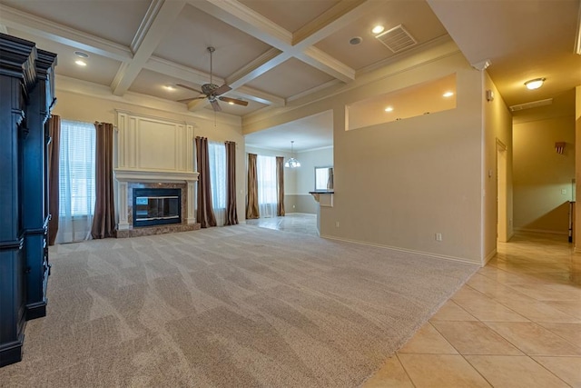 unfurnished living room featuring beamed ceiling, coffered ceiling, light tile patterned floors, light colored carpet, and ceiling fan