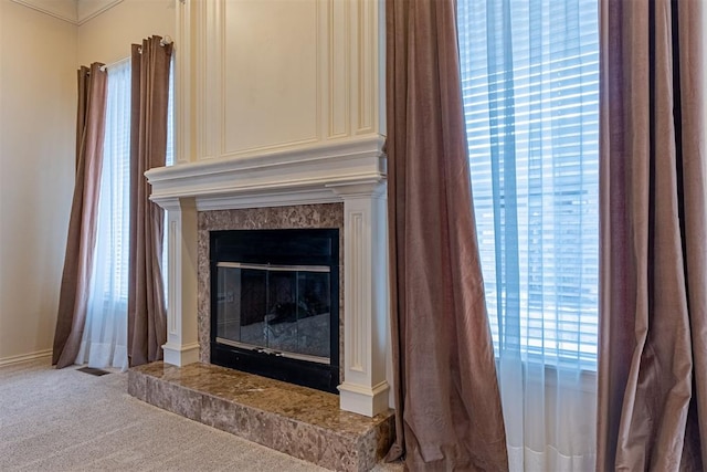 room details with a tiled fireplace and carpet flooring