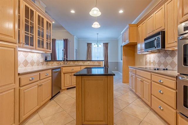 kitchen with ornamental molding, a sink, a kitchen island, stainless steel appliances, and a peninsula