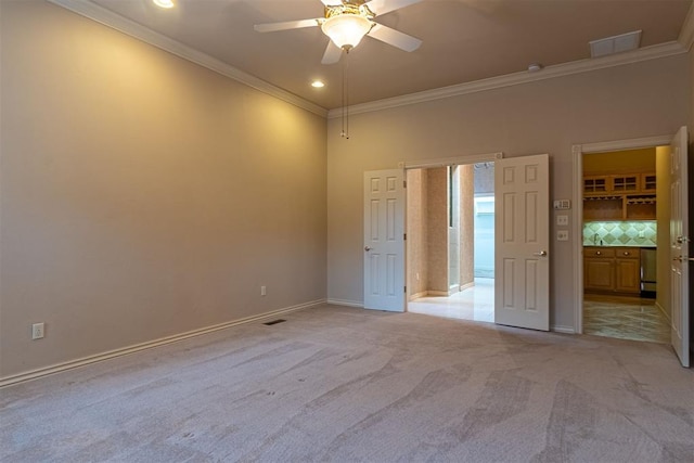 unfurnished bedroom with visible vents, ornamental molding, recessed lighting, baseboards, and light colored carpet