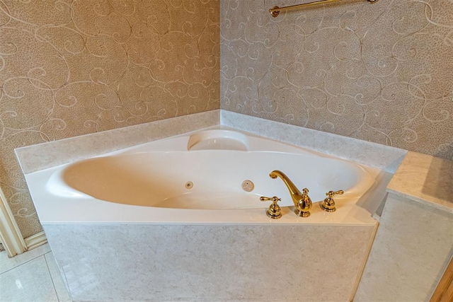 full bath with tile patterned floors, a bath, and wallpapered walls