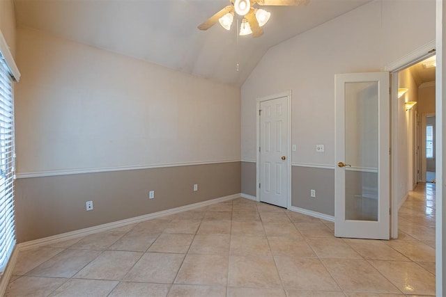 unfurnished bedroom with vaulted ceiling, baseboards, tile patterned floors, and ceiling fan