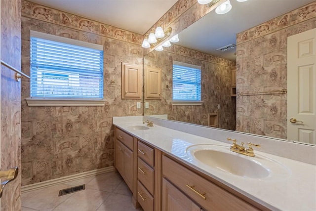 bathroom with a sink, visible vents, a wealth of natural light, and wallpapered walls