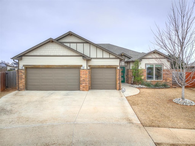 view of front of home with a garage, brick siding, driveway, and fence