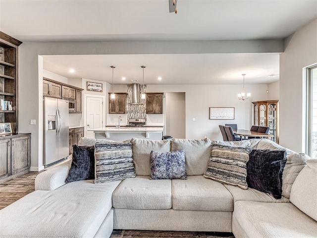 living area featuring recessed lighting, light wood-type flooring, and a chandelier