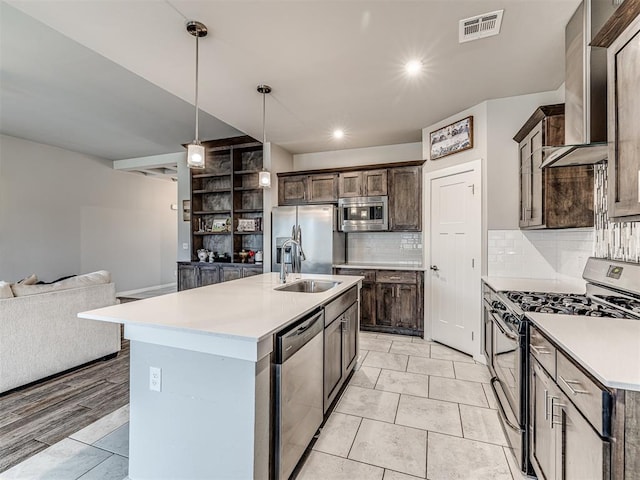 kitchen with a sink, dark brown cabinetry, visible vents, and stainless steel appliances