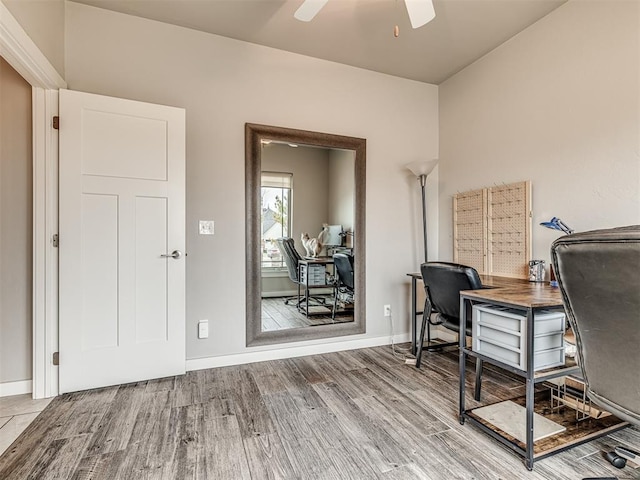 office space with baseboards, ceiling fan, and wood finished floors