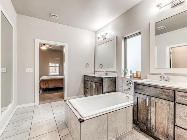 ensuite bathroom featuring ceiling fan, two vanities, visible vents, and a sink