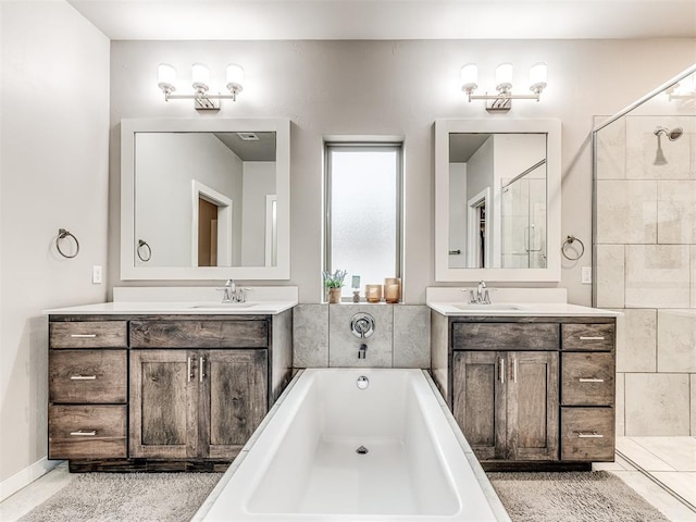 full bath featuring a sink, two vanities, and a bath