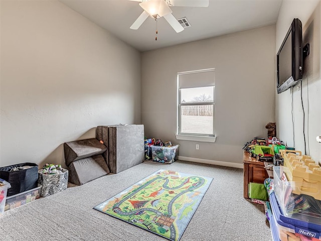 carpeted bedroom featuring a ceiling fan, baseboards, and visible vents