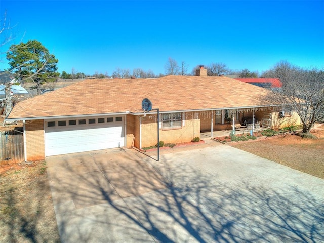 ranch-style house featuring fence, concrete driveway, a garage, brick siding, and a chimney