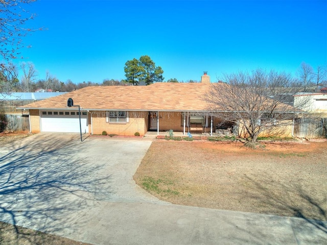 single story home with fence, an attached garage, a chimney, concrete driveway, and brick siding