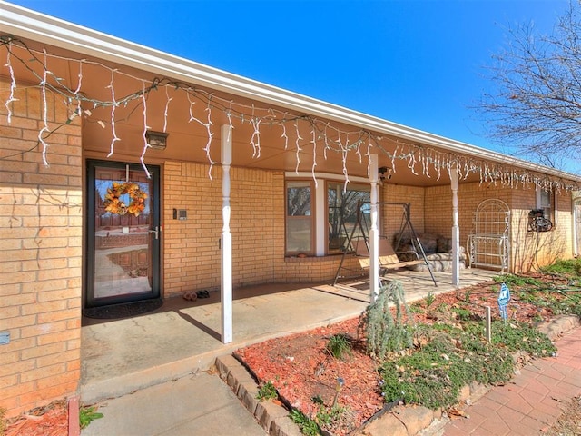 property entrance featuring brick siding