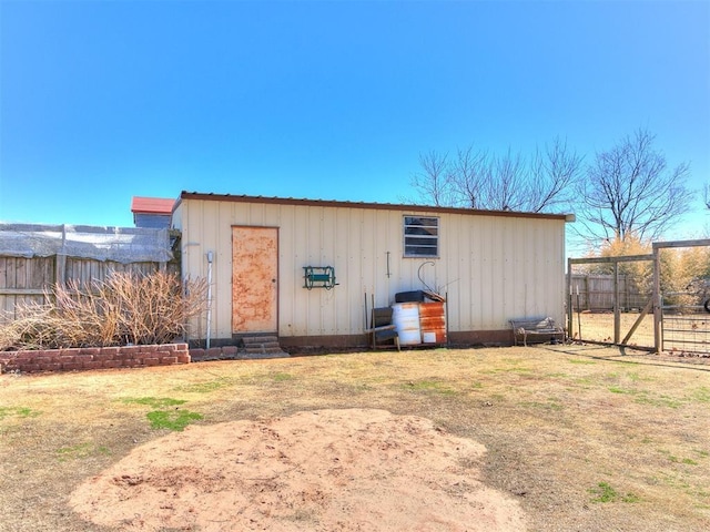 view of outdoor structure with an outbuilding and fence