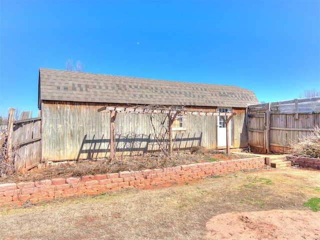 exterior space featuring an outdoor structure and fence