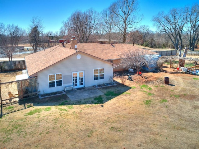 back of property featuring a patio, french doors, fence, and a lawn