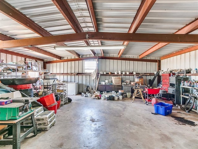 garage featuring a workshop area and metal wall