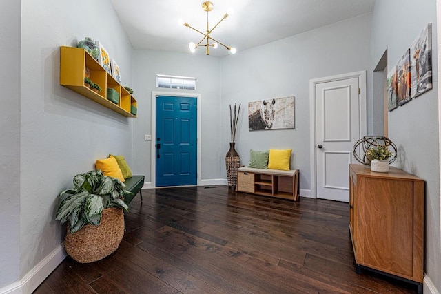 entrance foyer with hardwood / wood-style flooring, baseboards, and a chandelier