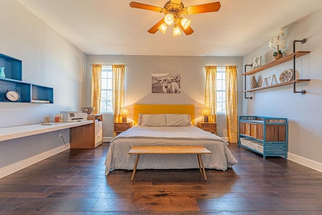 bedroom with dark wood-style floors, ceiling fan, and baseboards