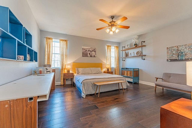 bedroom with baseboards, dark wood-type flooring, and a ceiling fan