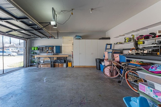 garage with a workshop area and a garage door opener