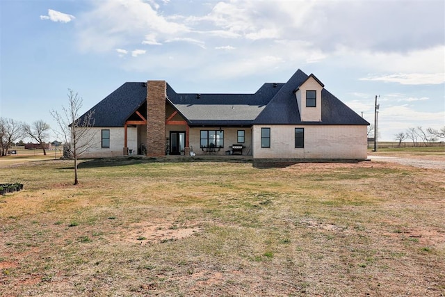view of front of house with a chimney and a front yard