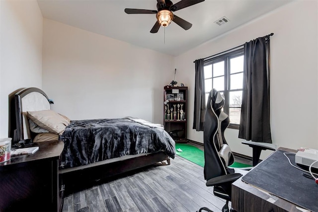bedroom with wood finished floors and a ceiling fan