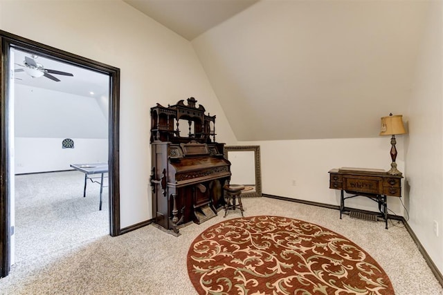 living area with carpet flooring, vaulted ceiling, ceiling fan, and baseboards