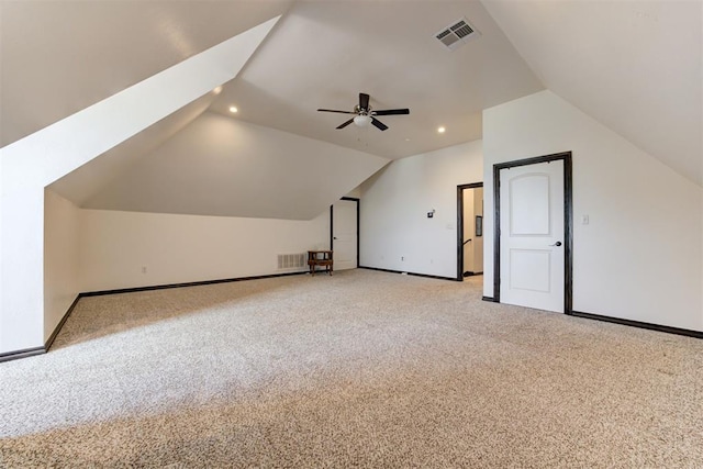 additional living space featuring vaulted ceiling, baseboards, light colored carpet, recessed lighting, and ceiling fan