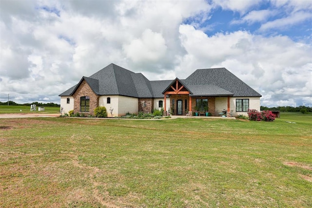 view of front of home with a front yard and brick siding