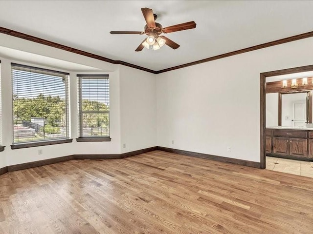 empty room with light wood finished floors, baseboards, crown molding, and a ceiling fan