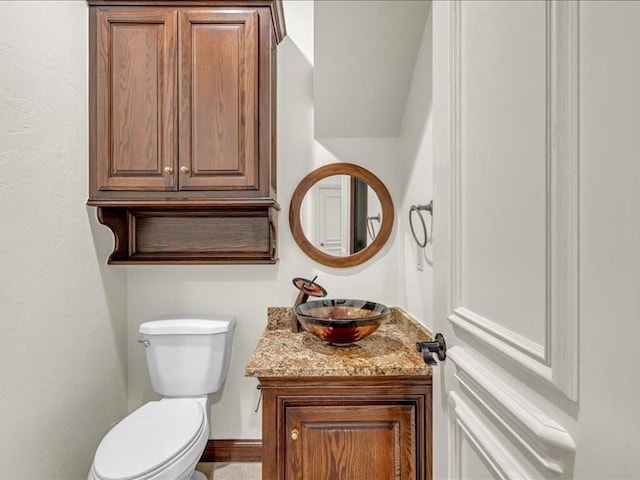 bathroom featuring toilet and vanity