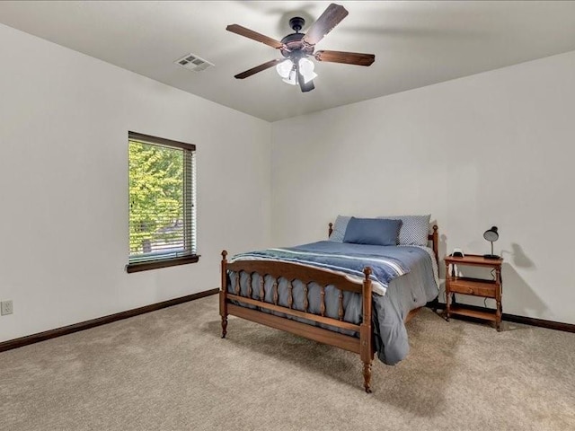 carpeted bedroom with baseboards, visible vents, and a ceiling fan