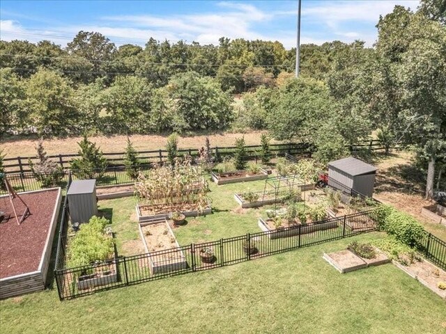 view of yard featuring fence and a vegetable garden