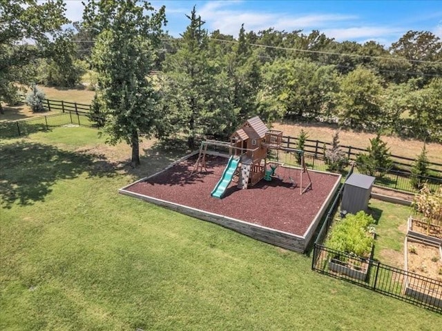 community play area with fence and a yard