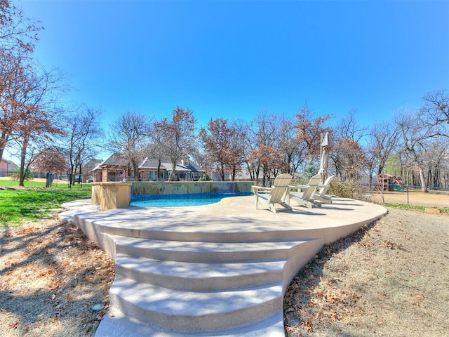 exterior space with a pool and fence