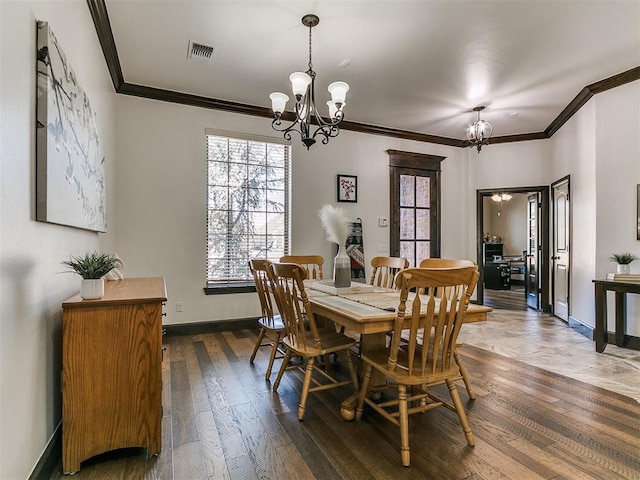 dining area with visible vents, baseboards, ornamental molding, an inviting chandelier, and dark wood-style flooring