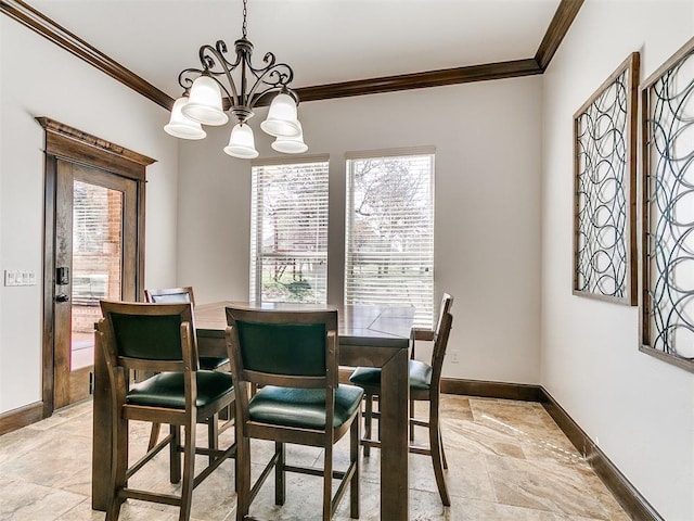 dining area featuring stone tile flooring, a notable chandelier, baseboards, and ornamental molding