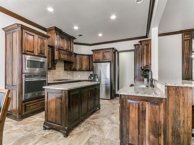 kitchen with light stone countertops, visible vents, a sink, decorative backsplash, and stainless steel appliances