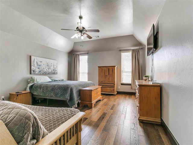 bedroom with visible vents, a ceiling fan, hardwood / wood-style flooring, baseboards, and vaulted ceiling