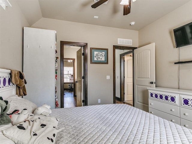 bedroom featuring lofted ceiling, a ceiling fan, and visible vents