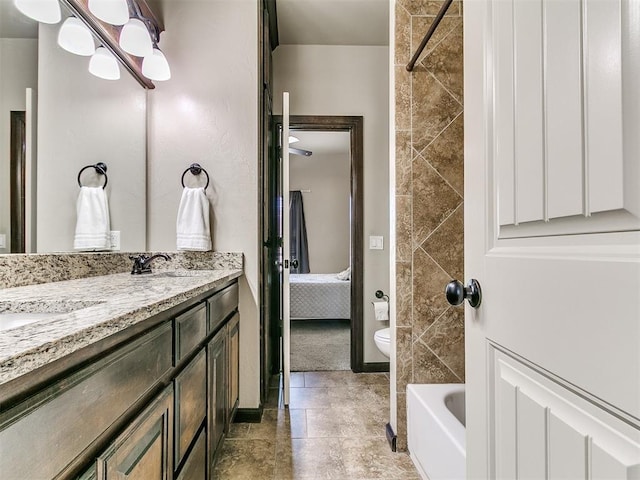 full bath with connected bathroom, a washtub, toilet, double vanity, and a sink