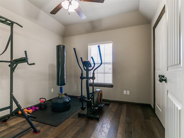 workout area featuring ceiling fan, baseboards, wood finished floors, and vaulted ceiling