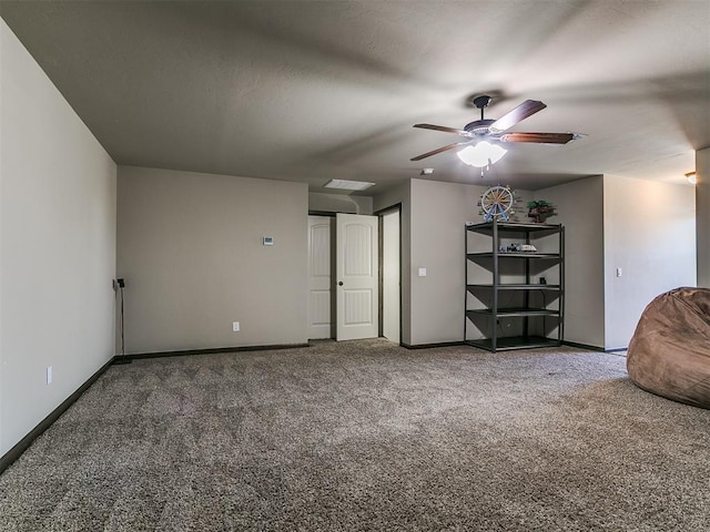 interior space with visible vents, baseboards, a ceiling fan, and carpet flooring